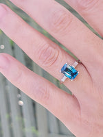 Platinum emerald cut blue zircon & baguette diamond estate ring