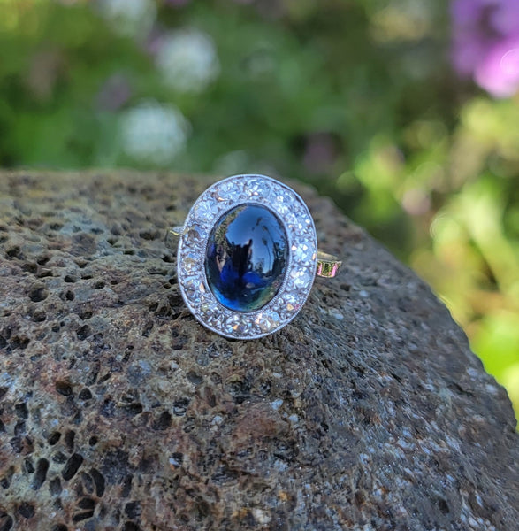 platinum cabochon blue sapphire halo estate ring
