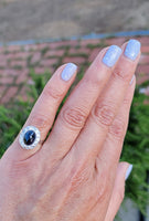platinum cabochon blue sapphire halo estate ring