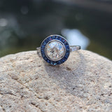 platinum European cut diamond & blue sapphire halo target ring