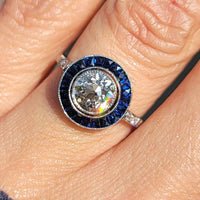 platinum European cut diamond & blue sapphire halo target ring