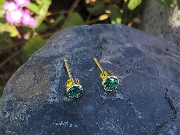 14k gold emerald bezel stud earrings - .19ct tw
